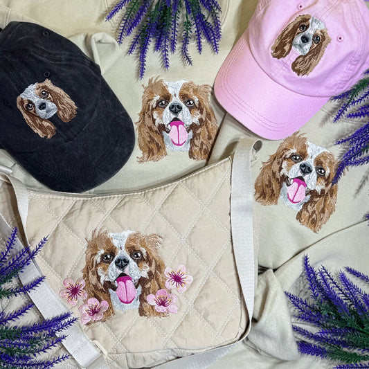 Embroidered dog designs on hats and a bag with lavender flowers.