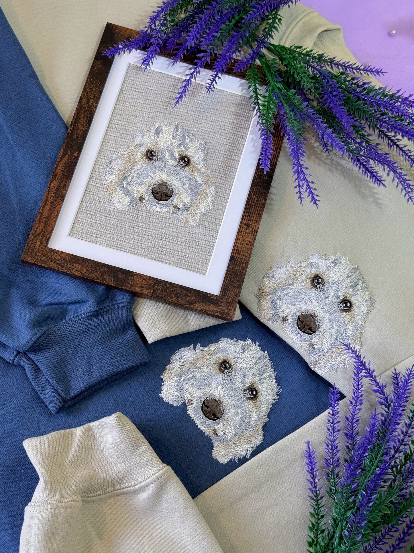 Framed cross-stitched dog portrait on fabric with lavender flowers