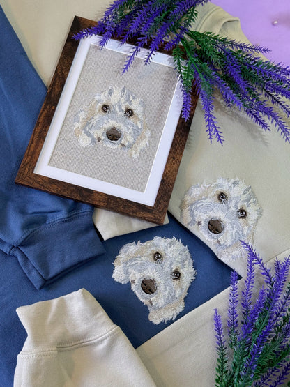 Framed cross-stitched dog portrait on fabric with lavender flowers