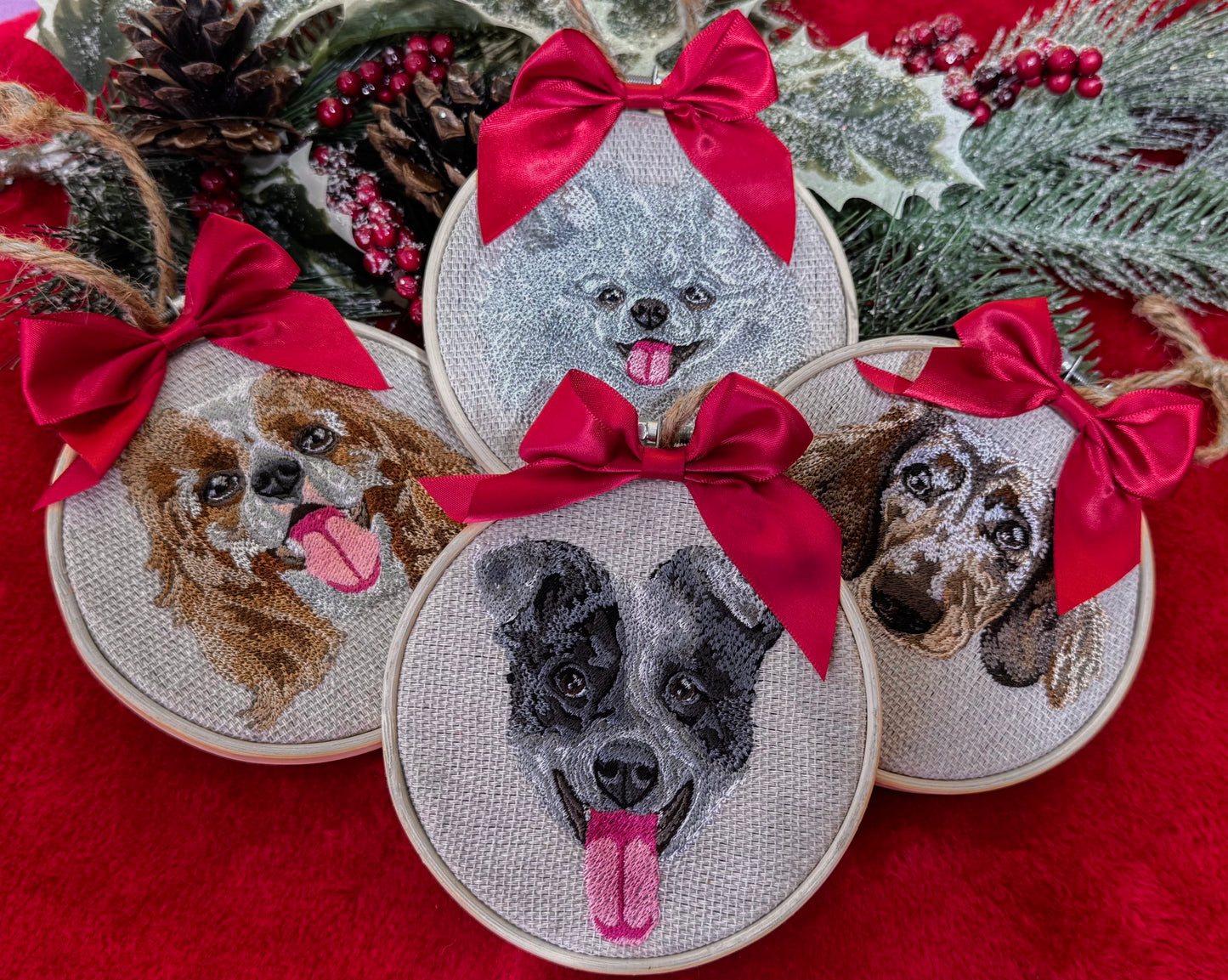 Custom embroidered dog portraits with red bows on a red fabric background