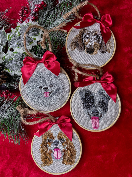 Set of embroidered dog portraits in embroidery hoops with red bows on a red background.