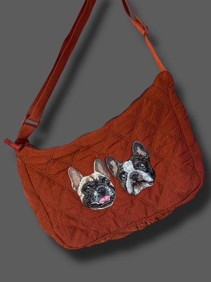 Red handbag with dog illustrations on a gray background