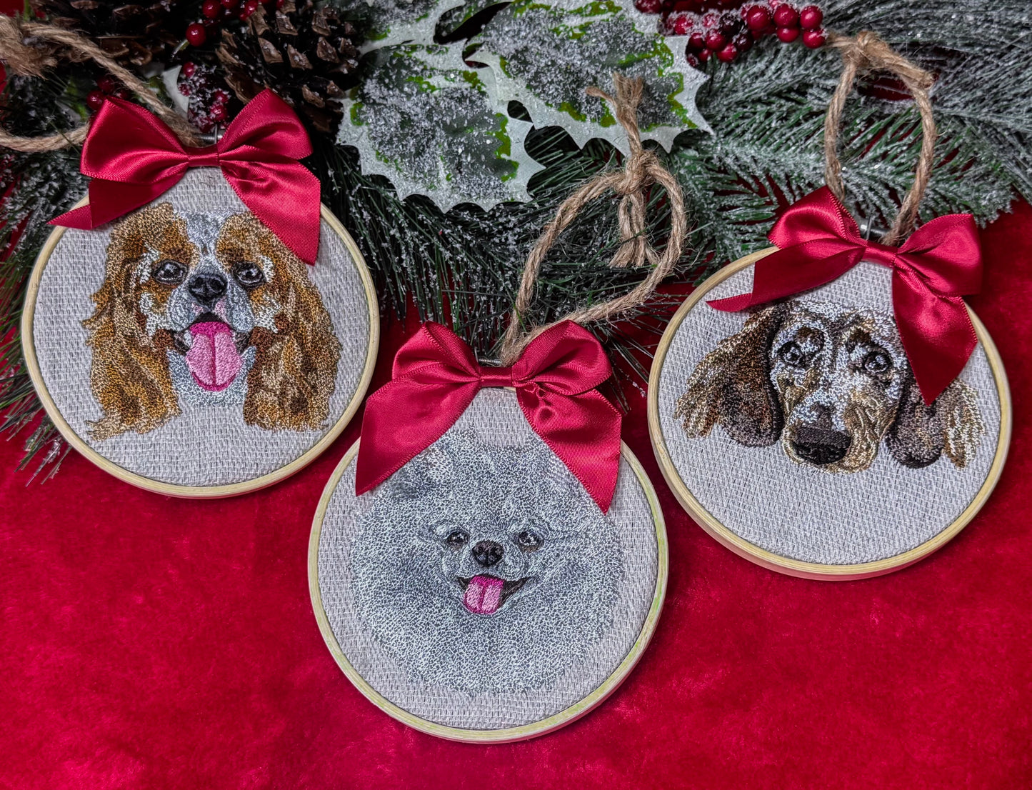 Embroidered dog portraits with red bows on a red fabric background