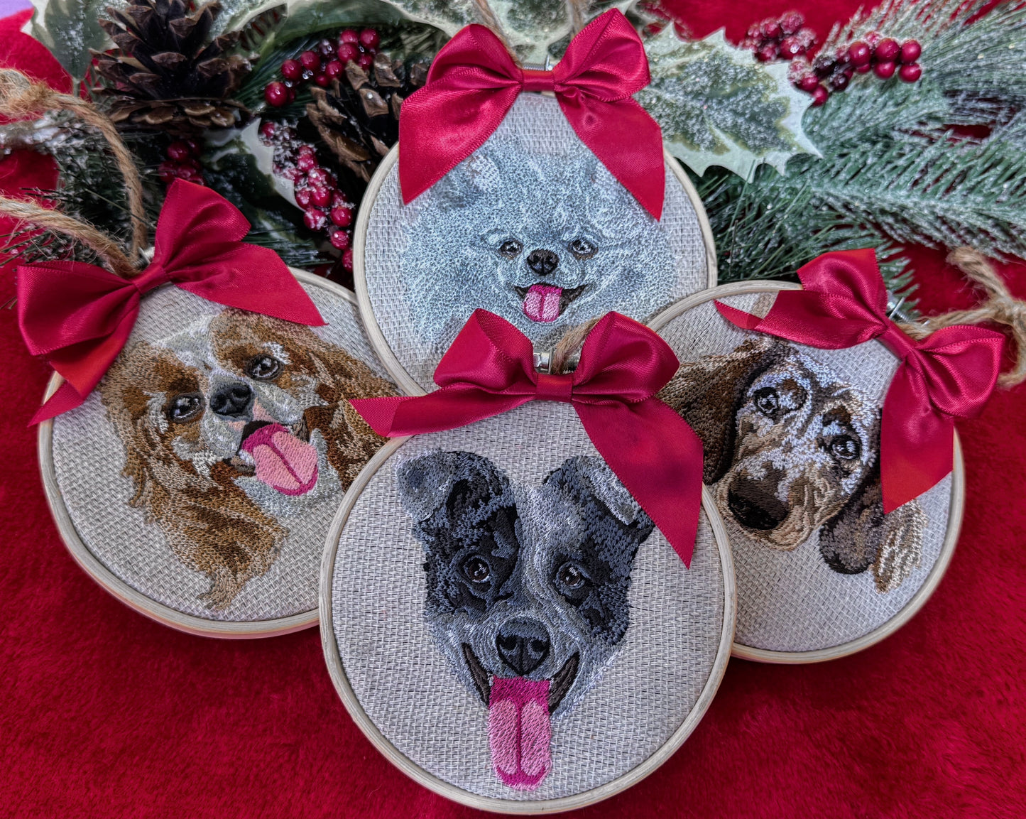 Embroidered dog portraits with red bows on a red fabric background