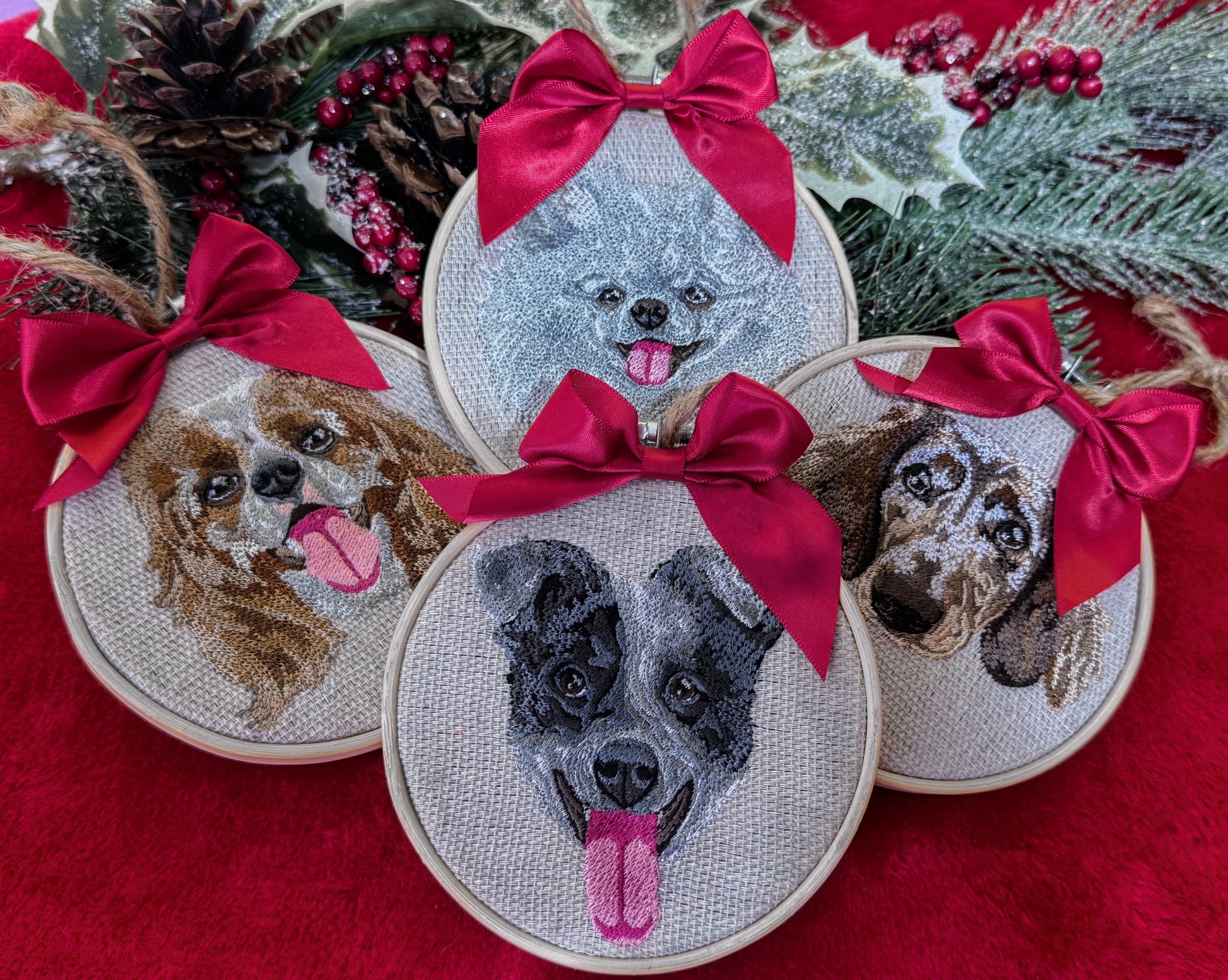 Embroidered dog portraits with red bows on a red fabric background